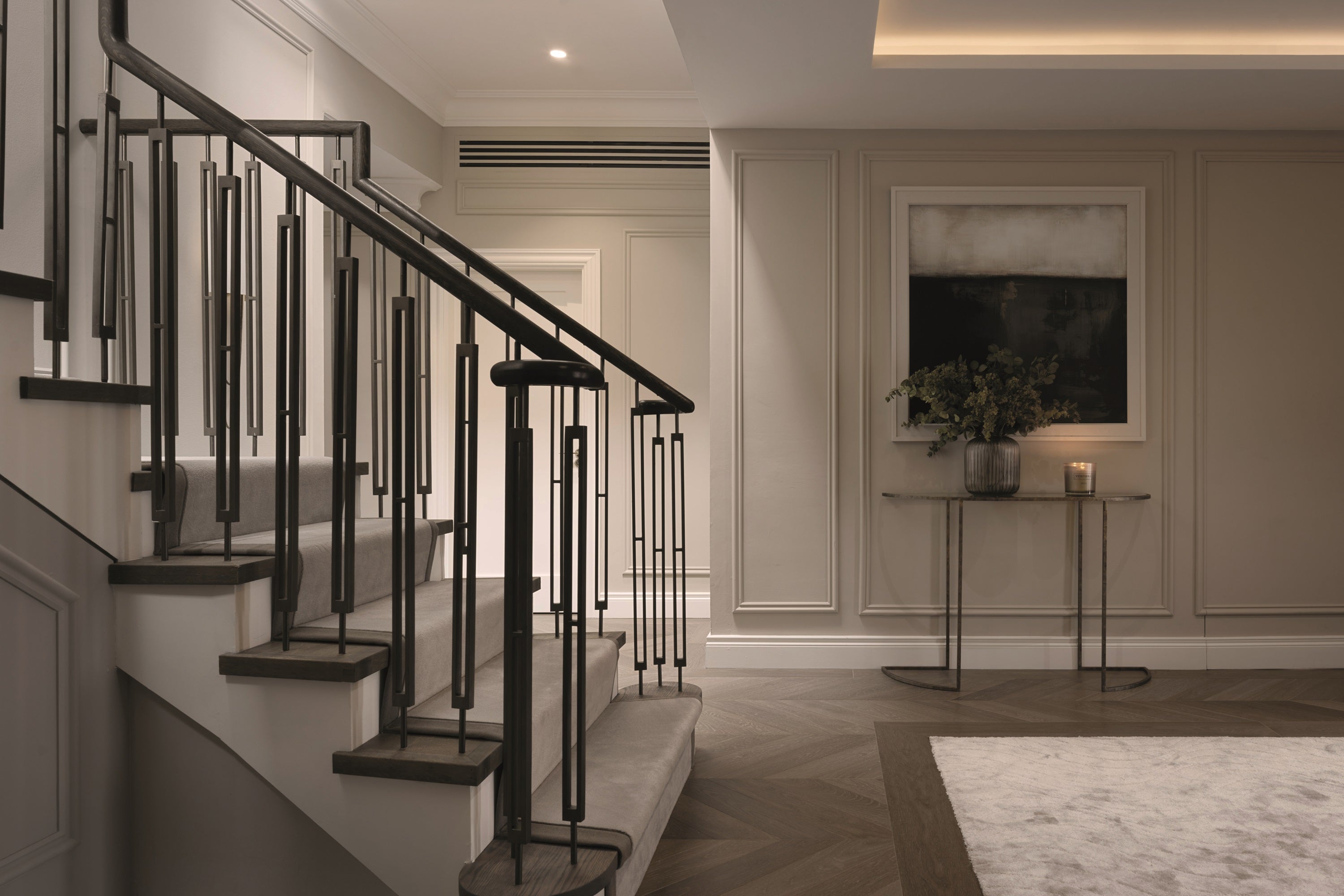 Staircase with black railings in a home interior setting.
