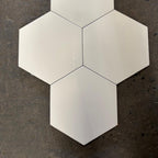 Hexagonal white tiles on a dark textured surface