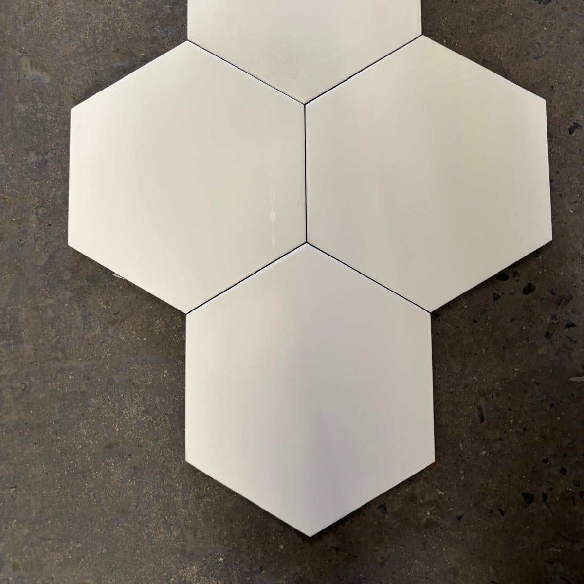 Hexagonal white tiles on a dark textured surface