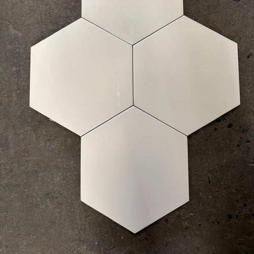 Hexagonal white tiles on a dark textured surface