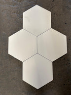 Hexagonal white tiles on a dark textured surface