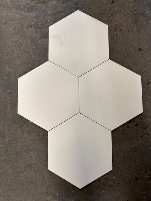 Hexagonal white tiles on a dark textured surface