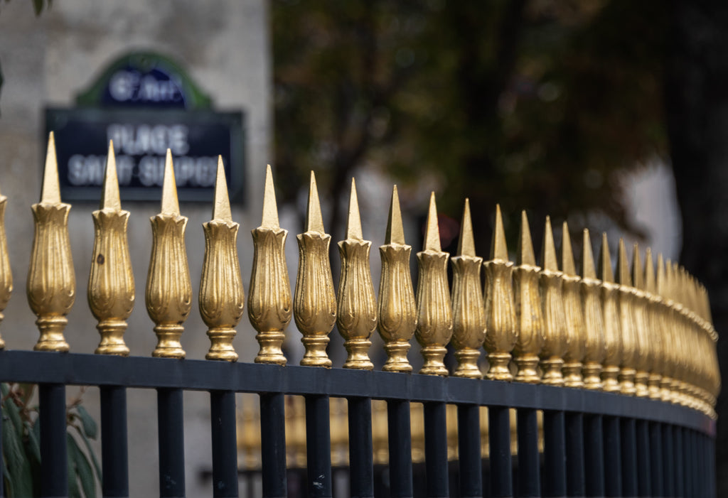 Gold spiked fence with blurred background