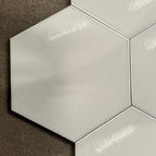 Hexagonal white tiles on a concrete floor