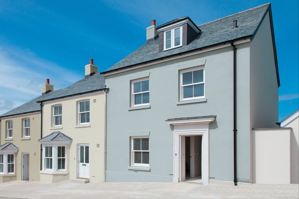 Two houses side by side with a clear blue sky above.